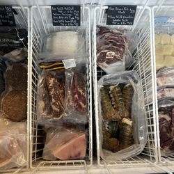 Surf & Turf - Display freezer featuring burgers, pork chops, halibut, porterhouse steaks, NY steaks, swordfish, lobster and scallops