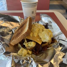 Bacon sandwich and cup of coffee. The picture captures the steam coming off the coffee. Bacon sandwich and cup of coffee. The picture captures the steam coming off the coffee.