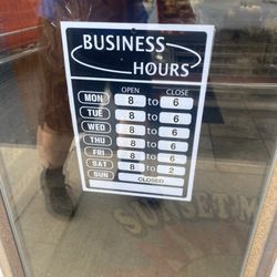 Sunset Meat Market - Store hours on the door