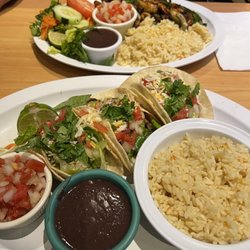 La Cocina de Mi Tierra - Foreground: chorizo taco and shrimp tacos. Background: mixed fajitas