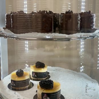 Dessert Elegance - a variety of desserts in a display case - Desserts Near Me