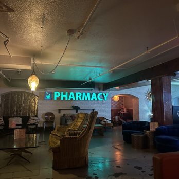 The Pharmacy - a neon sign in the lobby - Cocktail Bars Near Me - Seattle, Washington