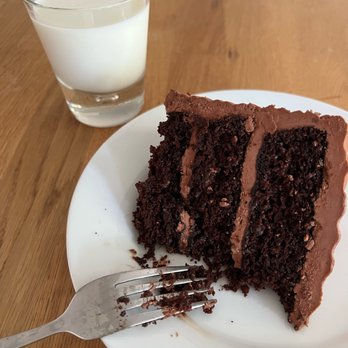 Betts Bakes - A slice of our decadent 3-layer chocolate cake with chocolate buttercream. - Cupcakes Near Me