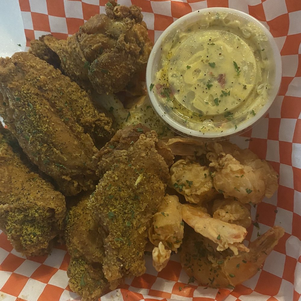 a basket of fried wings and a side of dip a basket of fried wings and a side of dip