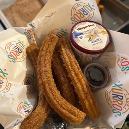 This was 8 churros with ice cream and chocolate dip This was 8 churros with ice cream and chocolate dip