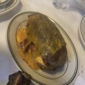 Majors Steakhouse - Baked potatoe with cheddar cheese and bacon - Steakhouses Near Me - East Meadow, New York Majors Steakhouse - Baked potatoe with cheddar cheese and bacon - Steakhouses Near Me - East Meadow, New York