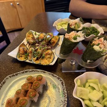 Tokyo Sushi - Bottom left: Hot Bae roll Top left: Baked mussels Hand rolls: Tahoe hand rolls Right: Cucumber Salad - Sushi Bars Near Me - Reno, Nevada Tokyo Sushi - Bottom left: Hot Bae roll Top left: Baked mussels Hand rolls: Tahoe hand rolls Right: Cucumber Salad - Sushi Bars Near Me - Reno, Nevada