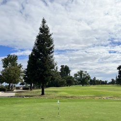 Riverside Golf Course - Putting area, view of course, and clubhouse to the left.