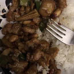 a plate of food with rice and a fork a plate of food with rice and a fork