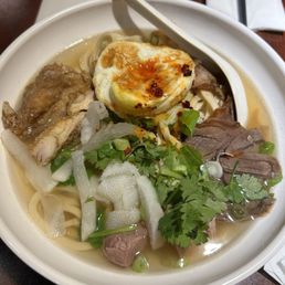 The Magic - hand pulled noodles in beef broth with beef shank slices, slow-braised herbal lamb chop, crunchy beef tripe, and fried egg The Magic - hand pulled noodles in beef broth with beef shank slices, slow-braised herbal lamb chop, crunchy beef tripe, and fried egg