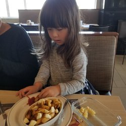 Le Gourmet - Dipping her Poutine into ketchup...