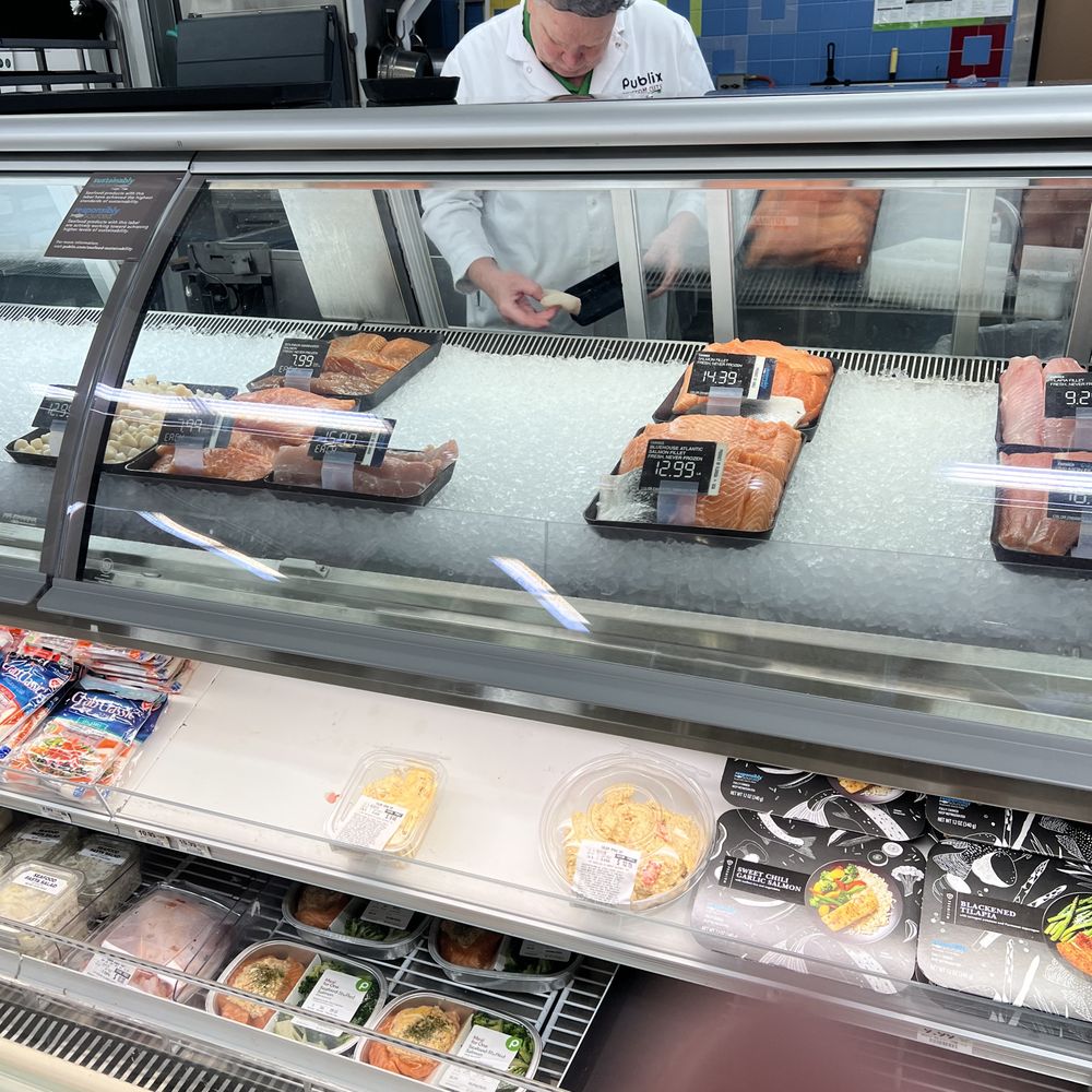Butcher handling raw fish without gloves Butcher handling raw fish without gloves