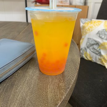 Antoinette's Cafe - Mango tea with pomegranate pearls - Coffee & Tea Near Me - Buford, Georgia