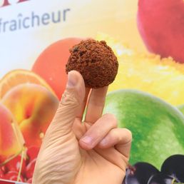 a hand holding a pastry