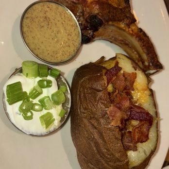 BJ's Restaurant & Brewhouse - Double bone in pork chop with Loaded Baked Potato. 3.5/5 - New American Near Me - Montebello, California