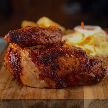 Crisp & Juicy - a piece of chicken on a cutting board - Peruvian Near Me - Frederick, Maryland Crisp & Juicy - a piece of chicken on a cutting board - Peruvian Near Me - Frederick, Maryland