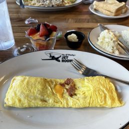 Ham and cheese three egg omelette with fruit and a biscuit