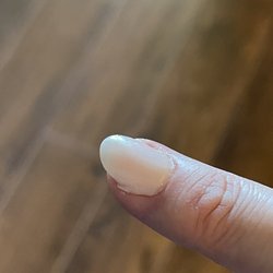 T'bro nails & Spa - Product is NOT contained to the nail. This looks bad, and will cause the product to lift and pop off.