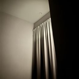 Outdoor light next to small window with thin blind - too much light flooding into room at night! Outdoor light next to small window with thin blind - too much light flooding into room at night!