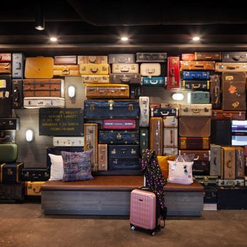 Moxy Halifax Downtown - Vintage luggage wall area in library - Hotels Near Me - Halifax, Nova Scotia