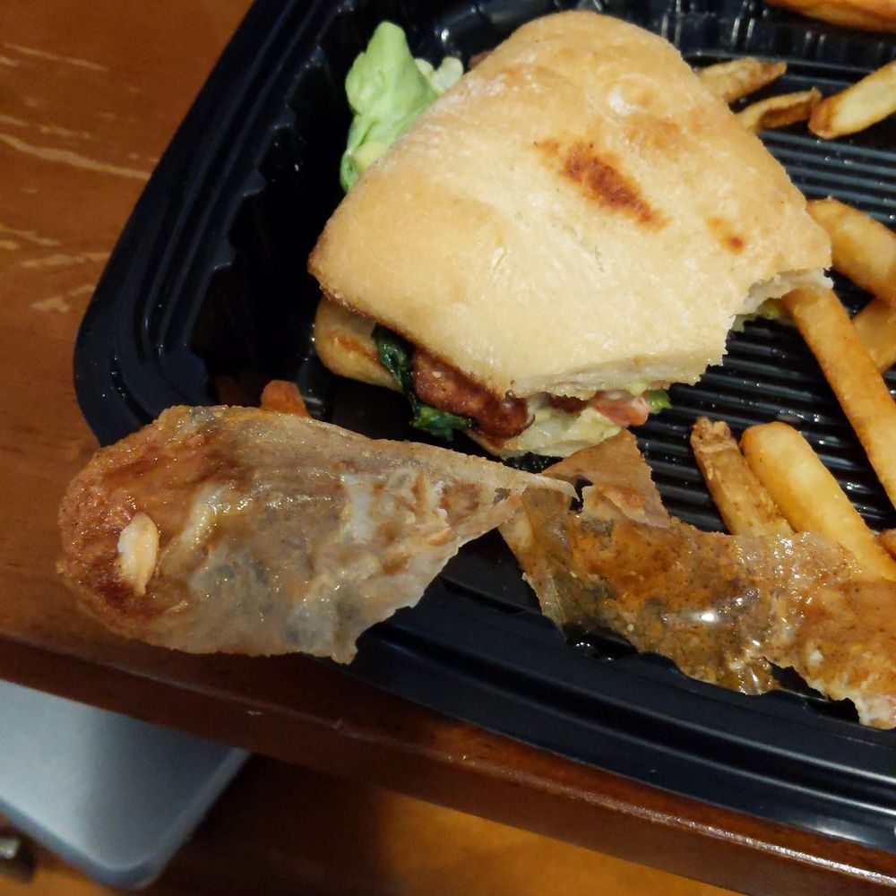 Fried pieces of wax paper pulled from chicken sandwich. Fried pieces of wax paper pulled from chicken sandwich.