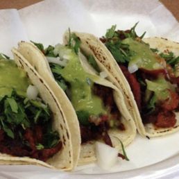 three tacos on a paper plate
