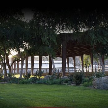 Global Sport Horse Stables - Indoor riding arena and grass area, indoor box stall barn in the background - Horseback Riding Near Me - Temecula, California Global Sport Horse Stables - Indoor riding arena and grass area, indoor box stall barn in the background - Horseback Riding Near Me - Temecula, California