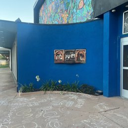 a blue building with graffiti on it a blue building with graffiti on it