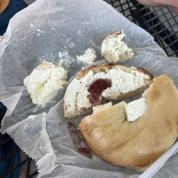 a half eaten bagel with a bite taken out of it