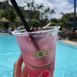 a hand holding a pink drink with a straw a hand holding a pink drink with a straw