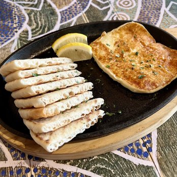 Portara Fresh Mediterranean - Saganaki fried cheese and pita bread - Mediterranean Near Me - Pearland, Texas Portara Fresh Mediterranean - Saganaki fried cheese and pita bread - Mediterranean Near Me - Pearland, Texas