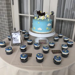 Frosted Creations - Baby Shower cake covered in buttercream with fondant figures and matching cupcakes with fondant toppers