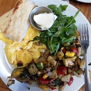 Photo of Estero Cafe - Valley Ford, CA, United States. The veggie hash with a biscuit and arugula.