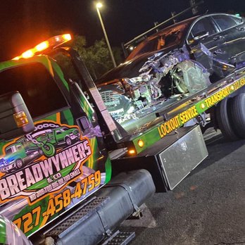 Breadwynners - a tow truck with a wrecked car on the back - Towing Near Me Breadwynners - a tow truck with a wrecked car on the back - Towing Near Me