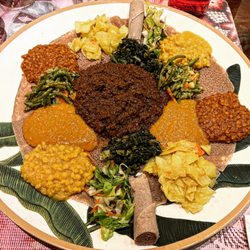 Mixed vegetarian platter with key wat (beef stew).