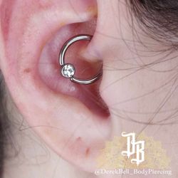 Ikonic Ink Tattoo & Piercing - Daith Piercing - Jewelry: Captive Bead Ring with clear CZ bezel bead. Done by our piercer: Derek Bell