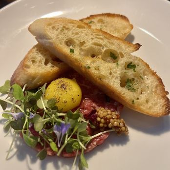 Vida - Beef tartare - caperberry, preserved lemon, quail egg yolk, pickled mustard seed, toasted baguette - New American Near Me - Indianapolis, Indiana