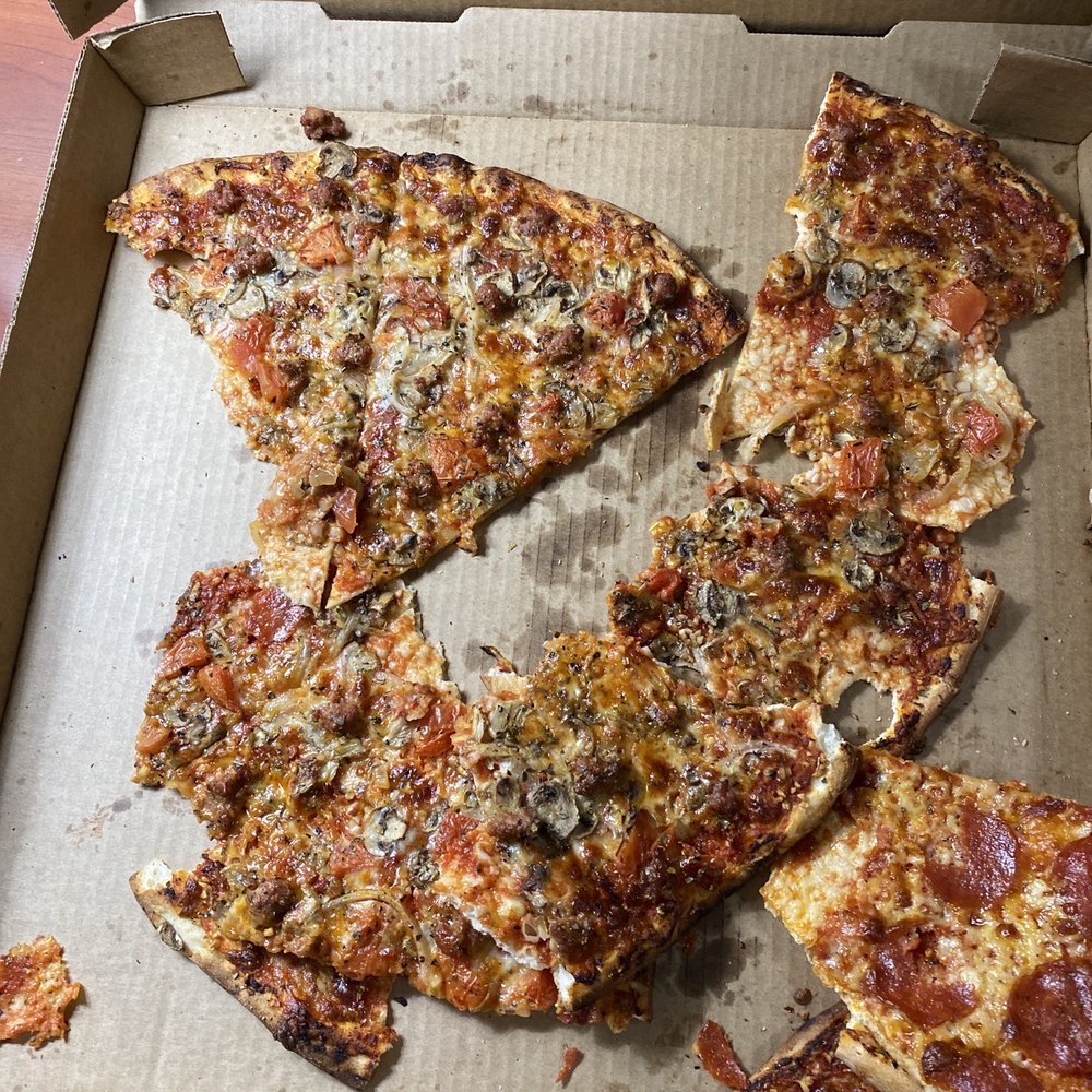 Sweet Basil Pizzeria - a half eaten pizza - Pizza Near Me - Walla Walla, Washington