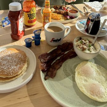 Egg Posh - Over easy eggs, pancakes, bacon and Gouda Cheese Grits with bacon and chives. So good - Breakfast & Brunch Near Me - Frisco, Texas Egg Posh - Over easy eggs, pancakes, bacon and Gouda Cheese Grits with bacon and chives. So good - Breakfast & Brunch Near Me - Frisco, Texas