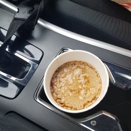 a cup of coffee in a cup holder a cup of coffee in a cup holder