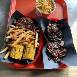In this photo you can see: mac & cheese, corn, fries, as well as pulled pork, and brisket. In this photo you can see: mac & cheese, corn, fries, as well as pulled pork, and brisket.