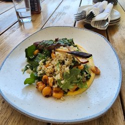 Barton's Kitchen Window - Two very small skewers of steak with an arugula salad