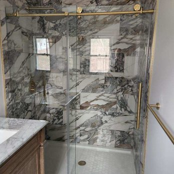 All-Skills Construction - a bathroom with a marble shower - General Contractors Near Me
