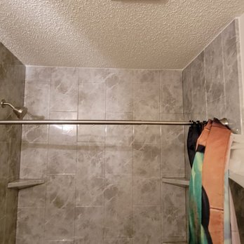 Re-Bath - a shower with a shower curtain - General Contractors Near Me - San Antonio, Texas Re-Bath - a shower with a shower curtain - General Contractors Near Me - San Antonio, Texas