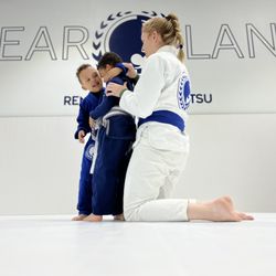 Renzo Gracie Pearland - Coach Jen guiding her students how to do the body lock.