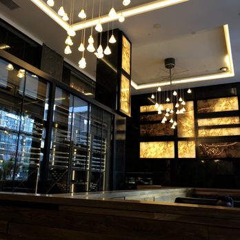 The Metropolitan At The Nine - a bar in a restaurant with a large chandelier - Lounges Near Me - Cleveland, Ohio The Metropolitan At The Nine - a bar in a restaurant with a large chandelier - Lounges Near Me - Cleveland, Ohio