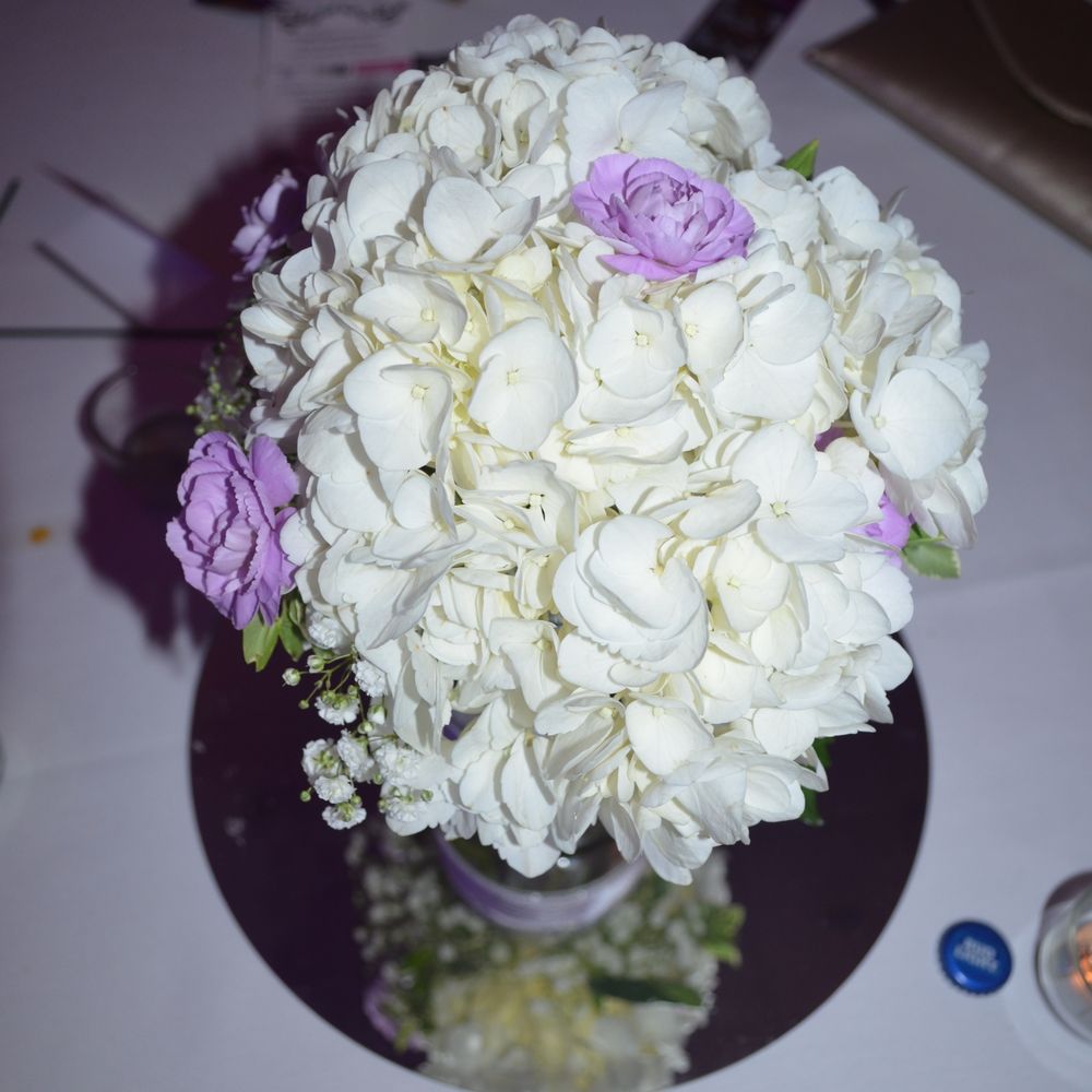 Personal Designs Florist - the center piece white hydrangeas with purple baby carnations and babies breath... they even put the ribbon on the mason jars I provided. - Florists Near Me - Rochester, New York Personal Designs Florist - the center piece white hydrangeas with purple baby carnations and babies breath... they even put the ribbon on the mason jars I provided. - Florists Near Me - Rochester, New York