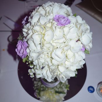 Personal Designs Florist - the center piece white hydrangeas with purple baby carnations and babies breath... they even put the ribbon on the mason jars I provided. - Florists Near Me - Rochester, New York Personal Designs Florist - the center piece white hydrangeas with purple baby carnations and babies breath... they even put the ribbon on the mason jars I provided. - Florists Near Me - Rochester, New York