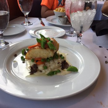 Ocean Prime - Sea Chilean Sea Bass in a bed of rice with hollandaise sauce - Seafood Near Me - Tampa, Florida Ocean Prime - Sea Chilean Sea Bass in a bed of rice with hollandaise sauce - Seafood Near Me - Tampa, Florida