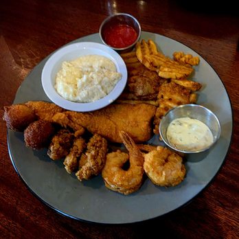 Charleston Crab House - Seafood platter - Fried flounder, shrimp, and oysters with waffle fries and grits! - Seafood Near Me - Charleston, South Carolina